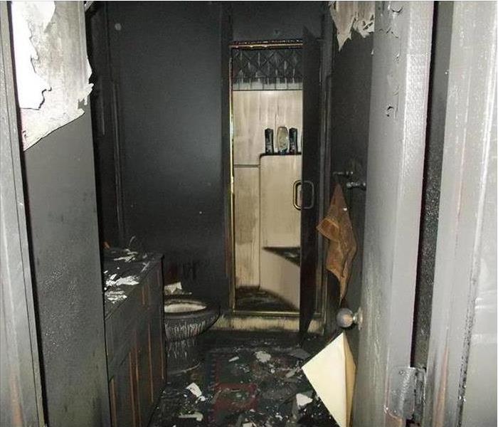 blackened bathroom, water and smoke-stained assemblies